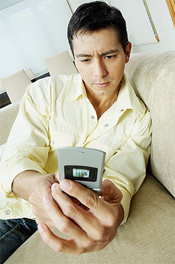 Man Reading From Old Phone which is basically the type of customer Mobimag is aiming for with their less than optimal launch excluding iPhone, Blackberry and Android phone users