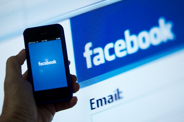 A view of an Apple iPhone displaying Facebook
