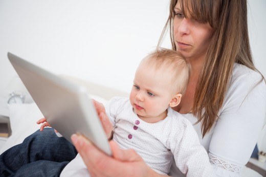 mom and baby with tablet via thinkstock