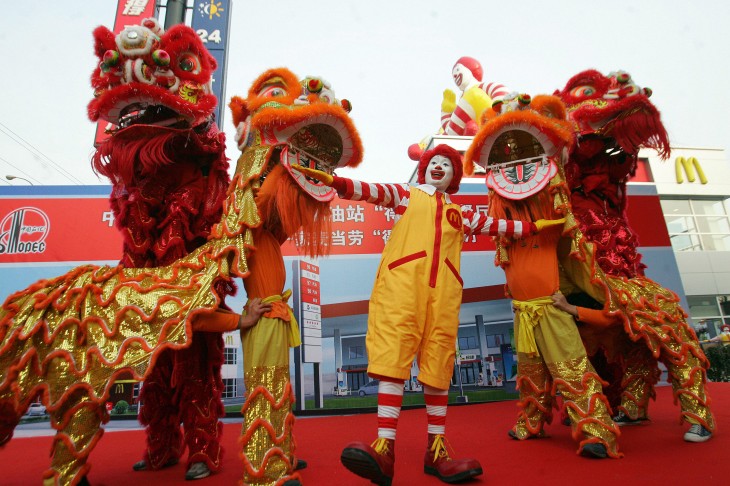 A lion dance troupe performs with Ronald
