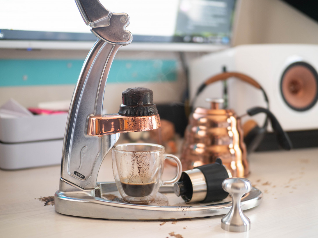 A Barista Using The Flair Espresso Maker Is A Non-electric Coffee Brewing  Device Using A Lever Or Handle. For Extracting Espresso On A Table With  Coffee Making Iced Coffee. Soft Focus Stock