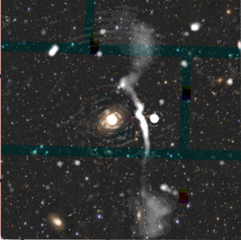 A giant radio galaxy with plumes of electrons stretching nearly 5 million light years from top to bottom of the image. These plumes had never been seen before the EMU Pilot Survey, even though the galaxy IC5063 (the bright blob in the centre) is a very well-studied galaxy. The radio emission (white) is superimposed on an optical imge (coloured) from the dark energy survey.