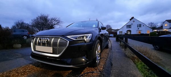 An electric car charges outside a home.