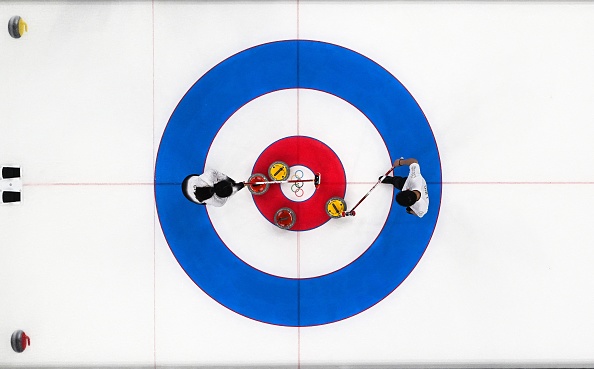 This picture taken with a robotic camera shows Chinas Ling Ahi (R) and Chinas Fan Suyuan (L) strategizing around the house during the mixed doubles round robin session 10 game of the Beijing 2022 Winter Olympic Games curling competition between Great Britain and China at the National Aquatics Centre in Beijing on February 6, 2022. (Photo by LILLIAN SUWANRUMPHA / AFP) (Photo by LILLIAN SUWANRUMPHA/AFP via Getty Images)