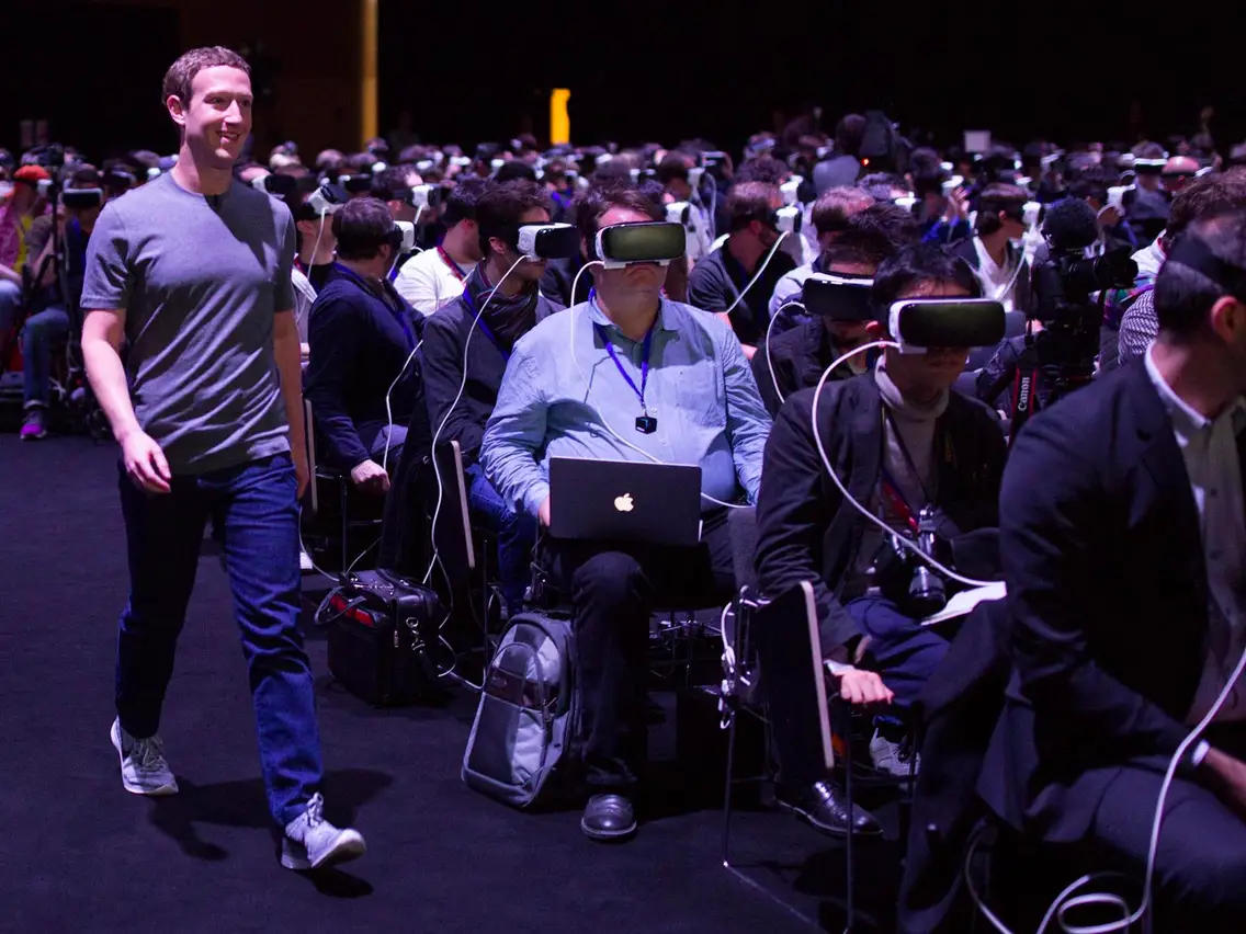 zuckerberg walking through room of VR headsets