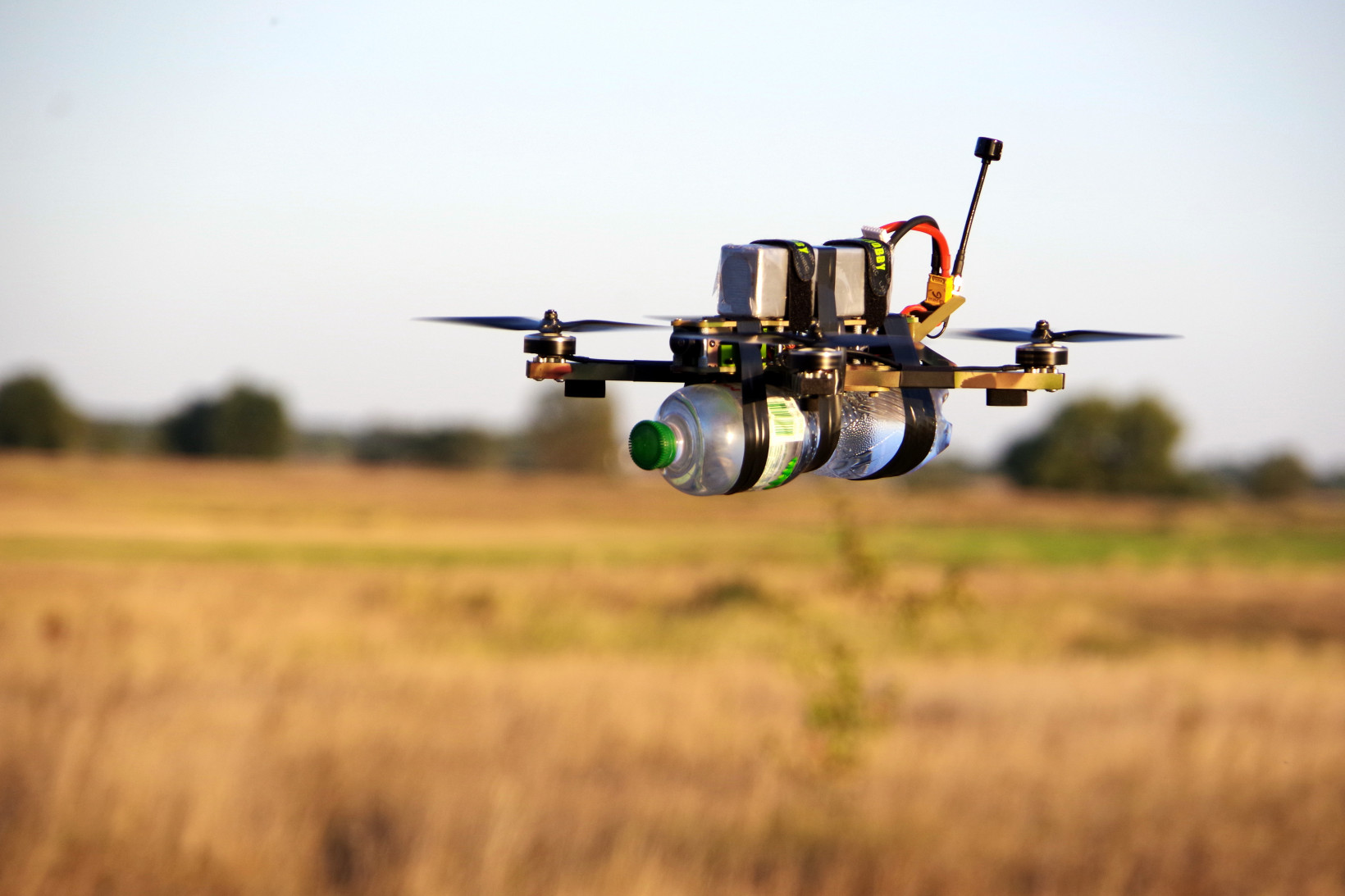 A drone flies over a field.  It was produced by Yakiv Ostash's startup Bank of Technologies "Celebrates" GMBH.
